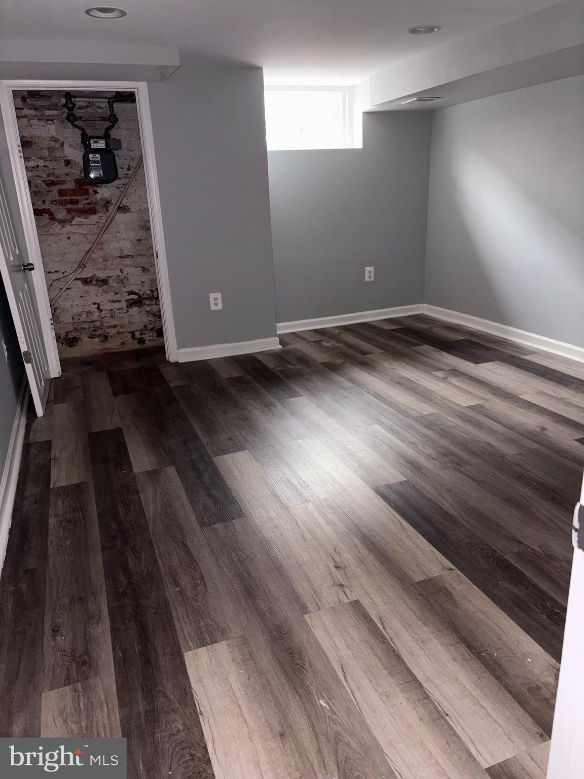 3413 Noble Street Baltimore, MD 21224 - Photo 27 of 43 a view of a hallway with wooden floor