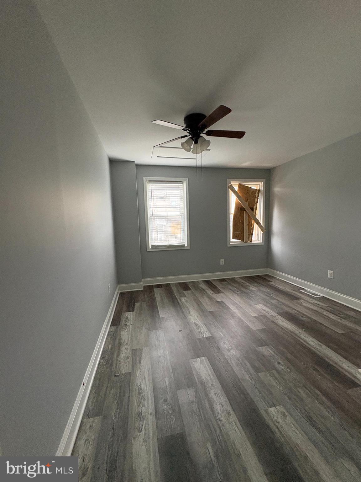 3413 Noble Street Baltimore, MD 21224 - Photo 9 of 43 an empty room with wooden floor and windows
