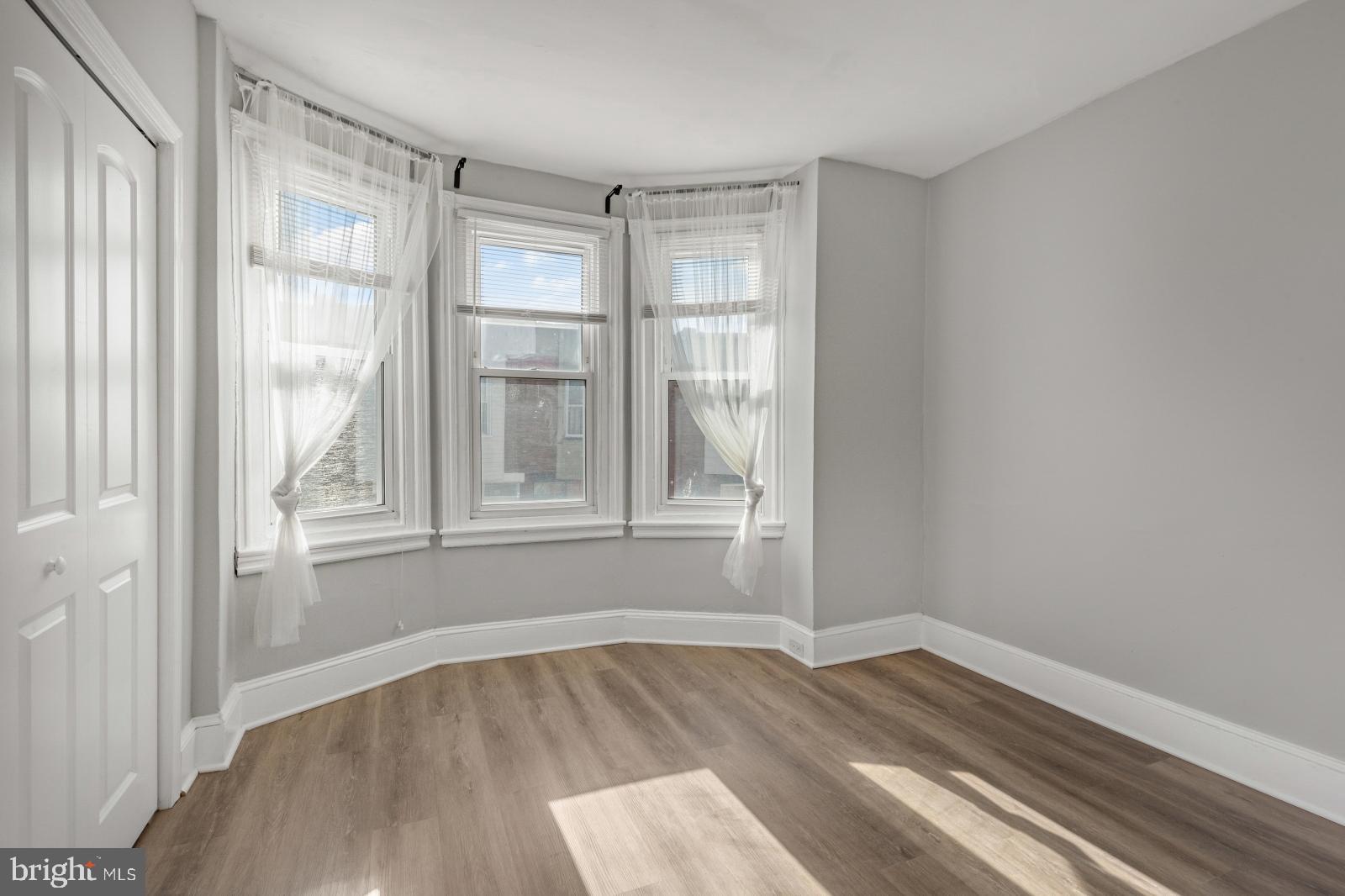 103 Daly Street Philadelphia, PA 19148 - Photo 17 of 23 a view of wooden floor and windows in a room