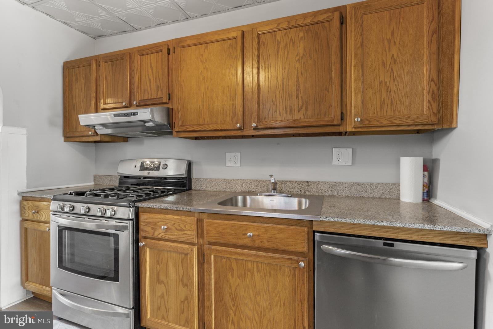 103 Daly Street Philadelphia, PA 19148 - Photo 8 of 23 a kitchen with stainless steel appliances granite countertop a stove a sink dishwasher and cabinets with wooden floor