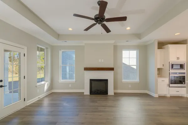 a large kitchen with stainless steel appliances kitchen island granite countertop a sink refrigerator and cabinets
