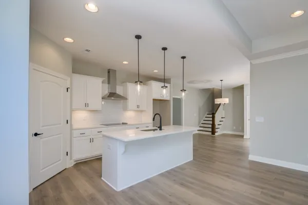 a kitchen with a sink a counter space appliances and cabinets
