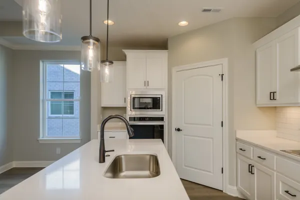 a kitchen with a sink a counter space and a window