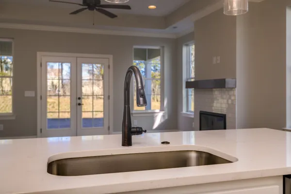 a view of a kitchen center island and stainless steel appliances