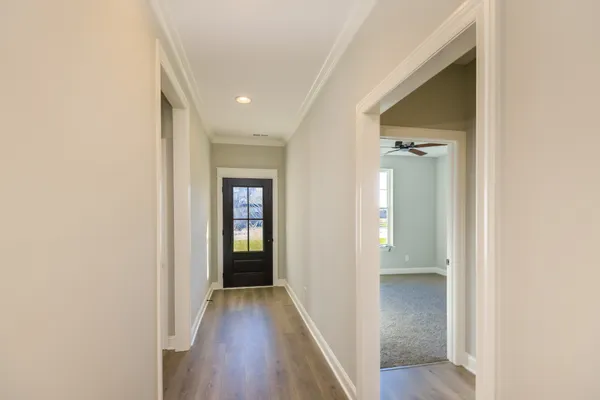 a view of an empty room with a window and fireplace