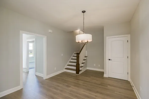 a view of entryway and hall with wooden floor