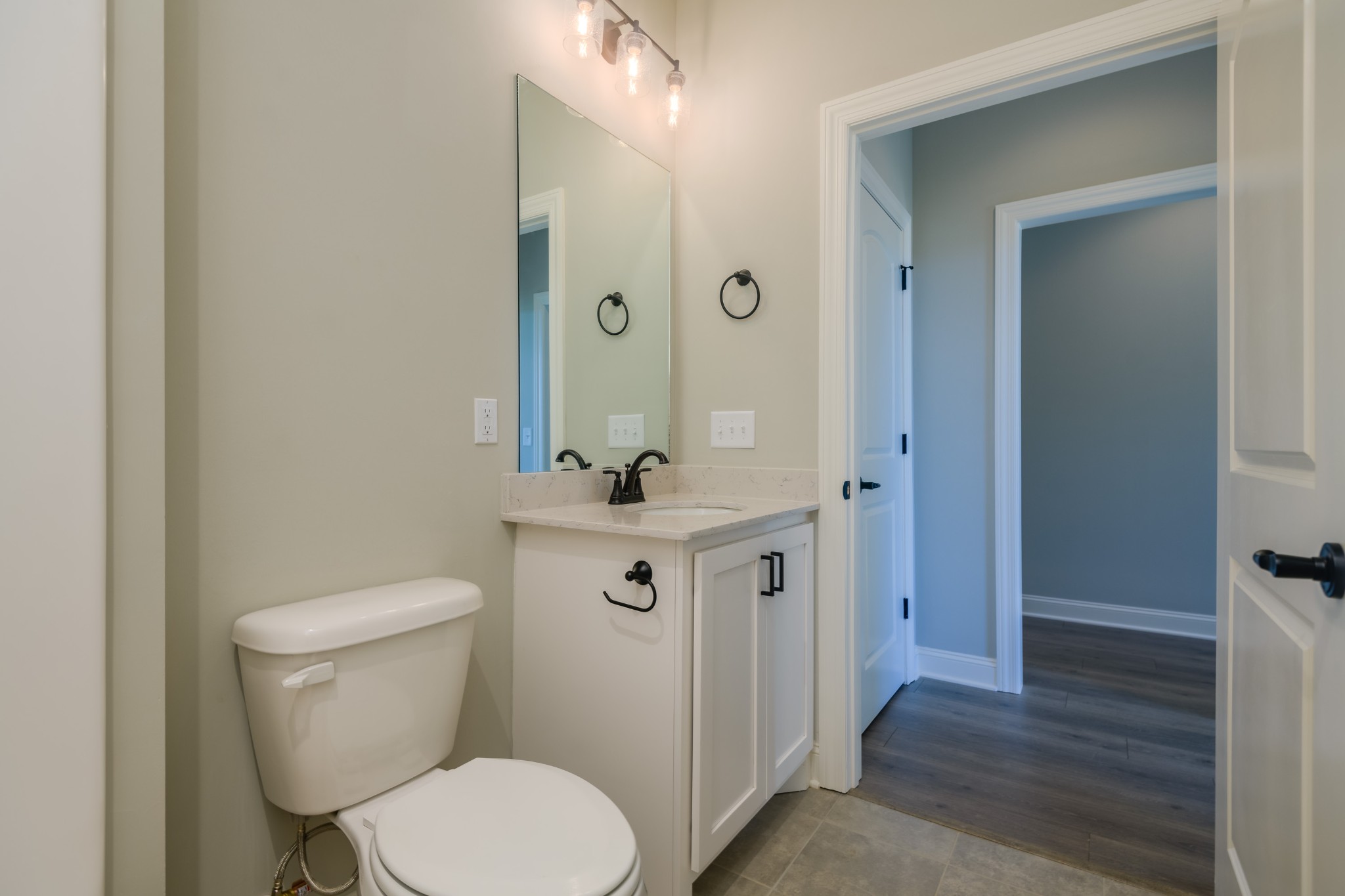 2290 Midland Road, Unit 7A Shelbyville, TN 37160 - Photo 8 of 44 a bathroom with a toilet a sink a mirror and vanity