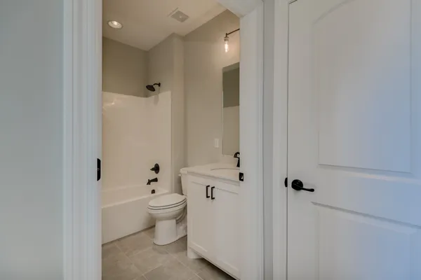 a bathroom with a granite countertop sink mirror and shower