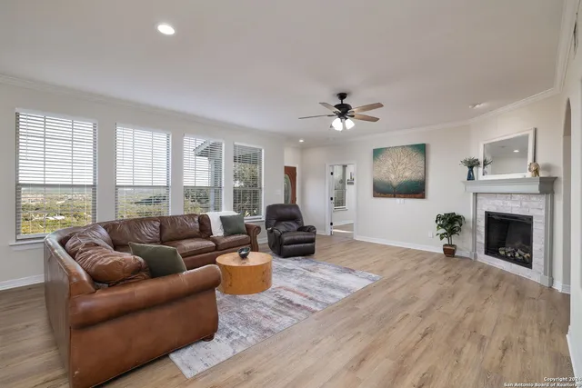 a living room with furniture fireplace and window