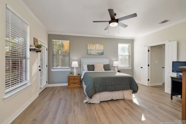 a spacious bedroom with a bed and window