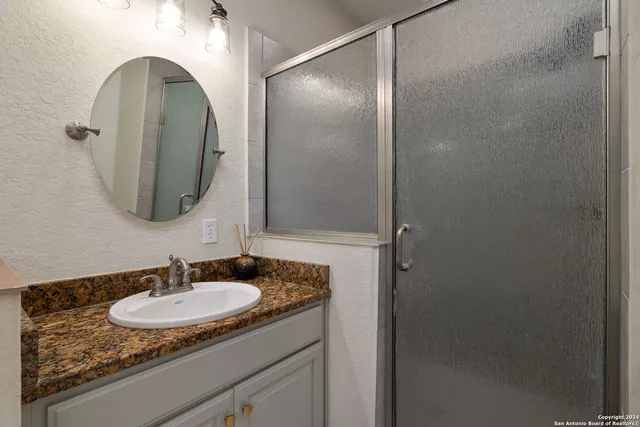 a bathroom with a sink and a mirror