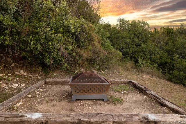 a backyard of a house with a yard and trampoline