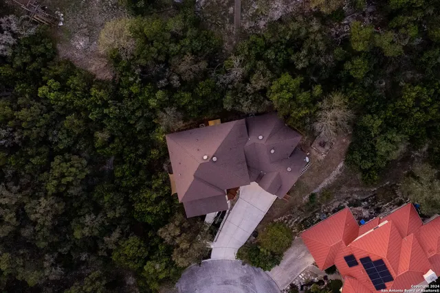 an aerial view of a house with a yard and garden