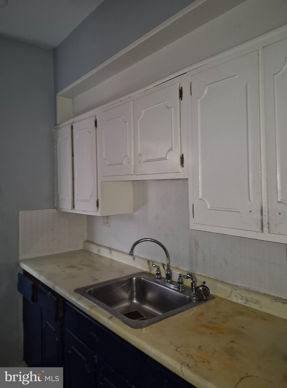 5016 Newhall Street Philadelphia, PA 19144 - Photo 3 of 4 a kitchen with white cabinets a sink and dishwasher