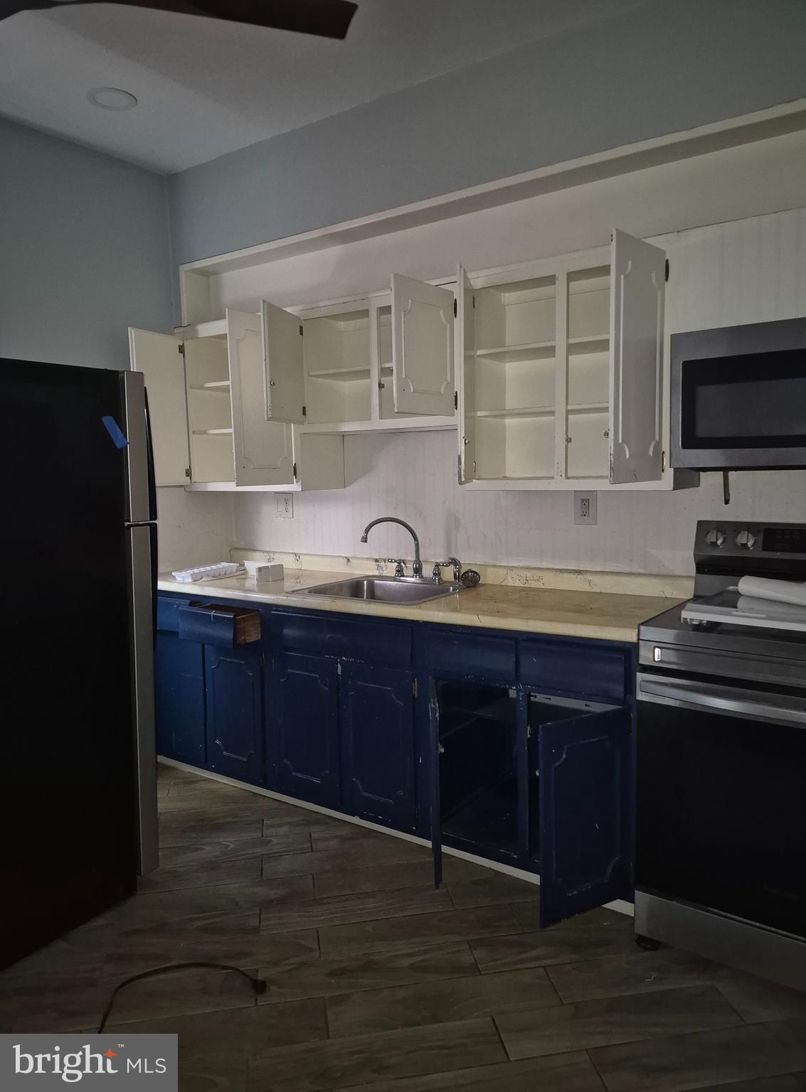 5016 Newhall Street Philadelphia, PA 19144 - Photo 4 of 4 a kitchen with granite countertop wooden cabinets and stainless steel appliances