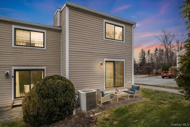 a view of a house with backyard and sitting area