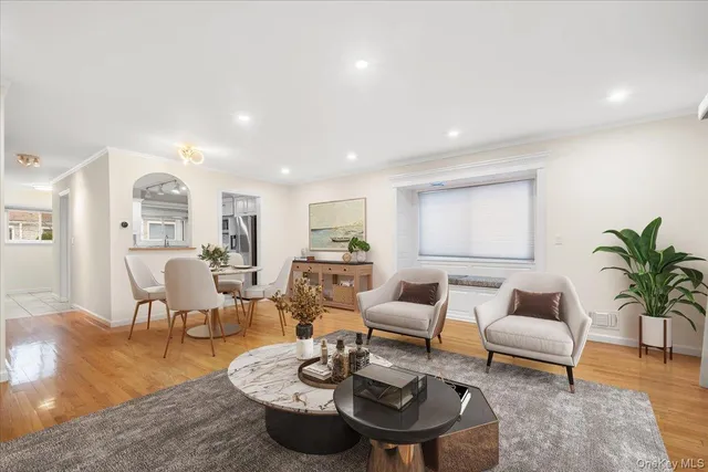 a living room with furniture rug and wooden floor
