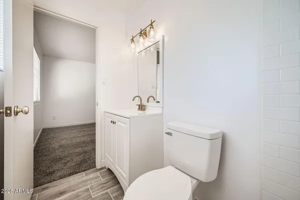 a white toilet sitting next to a bathroom sink