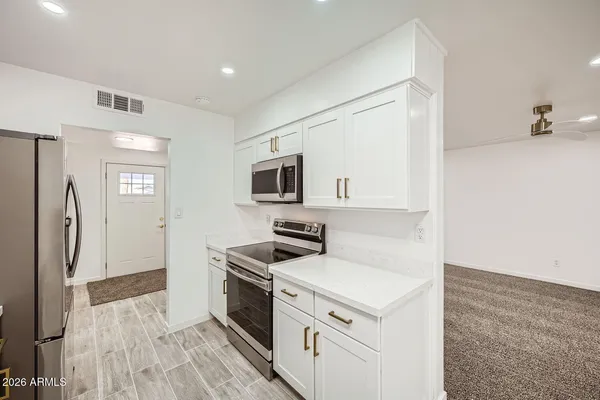 a kitchen with a stove sink and a refrigerator