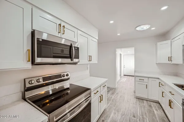 a kitchen with microwave stove and cabinets