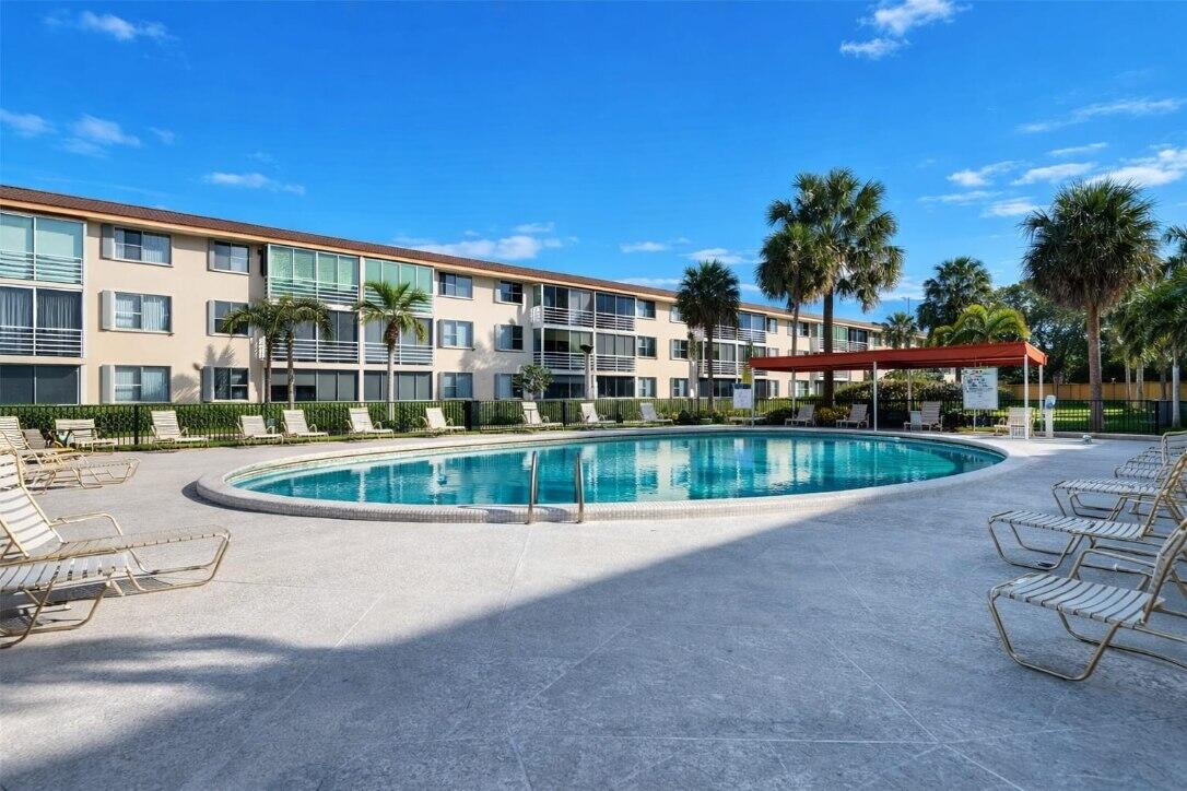 4500 North Federal Highway, Unit 121C Lighthouse Point, FL 33064 - Photo 1 of 14 a view of a house with a swimming pool and sitting area