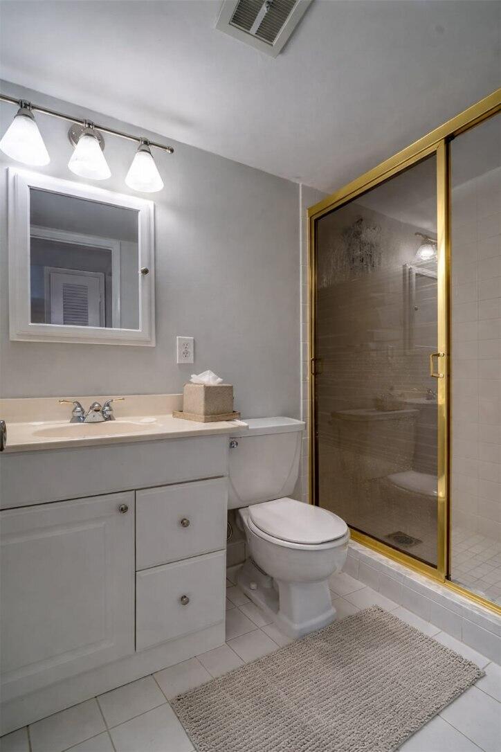 4500 North Federal Highway, Unit 121C Lighthouse Point, FL 33064 - Photo 12 of 14 a bathroom with a shower sink vanity mirror and toilet