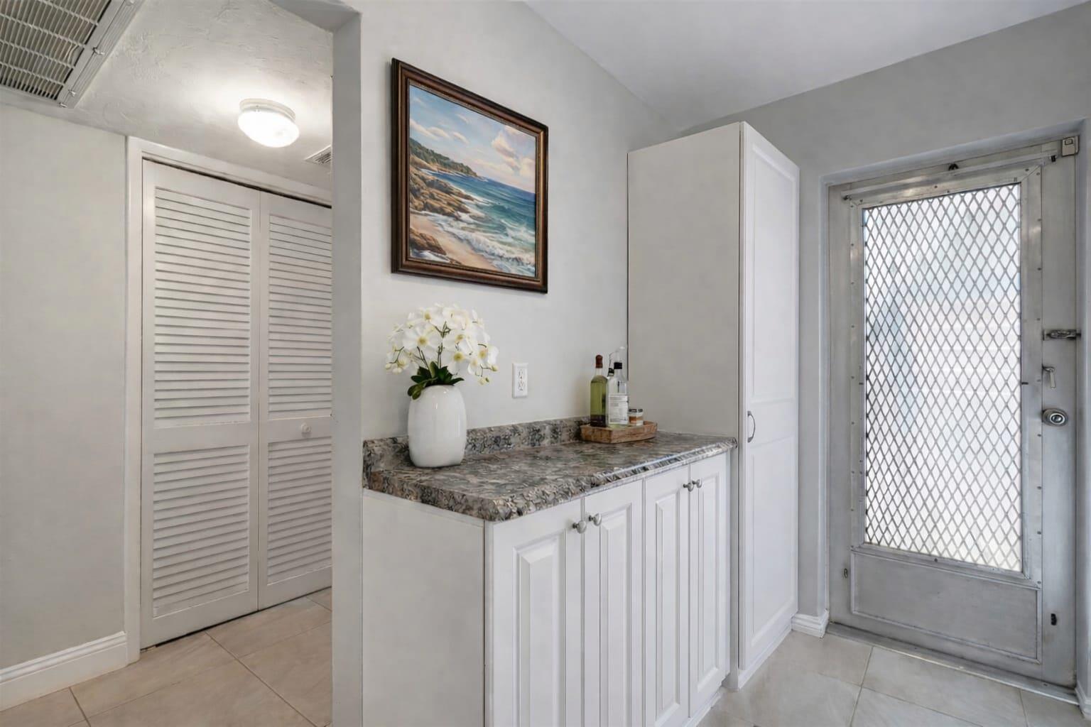 4500 North Federal Highway, Unit 121C Lighthouse Point, FL 33064 - Photo 2 of 14 a bathroom with a granite countertop sink and a mirror