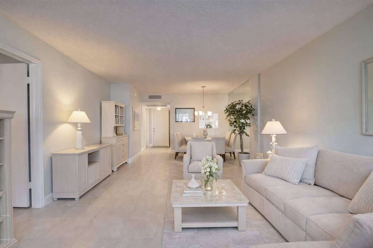 4500 North Federal Highway, Unit 121C Lighthouse Point, FL 33064 - Photo 3 of 14 a living room with furniture and a chandelier