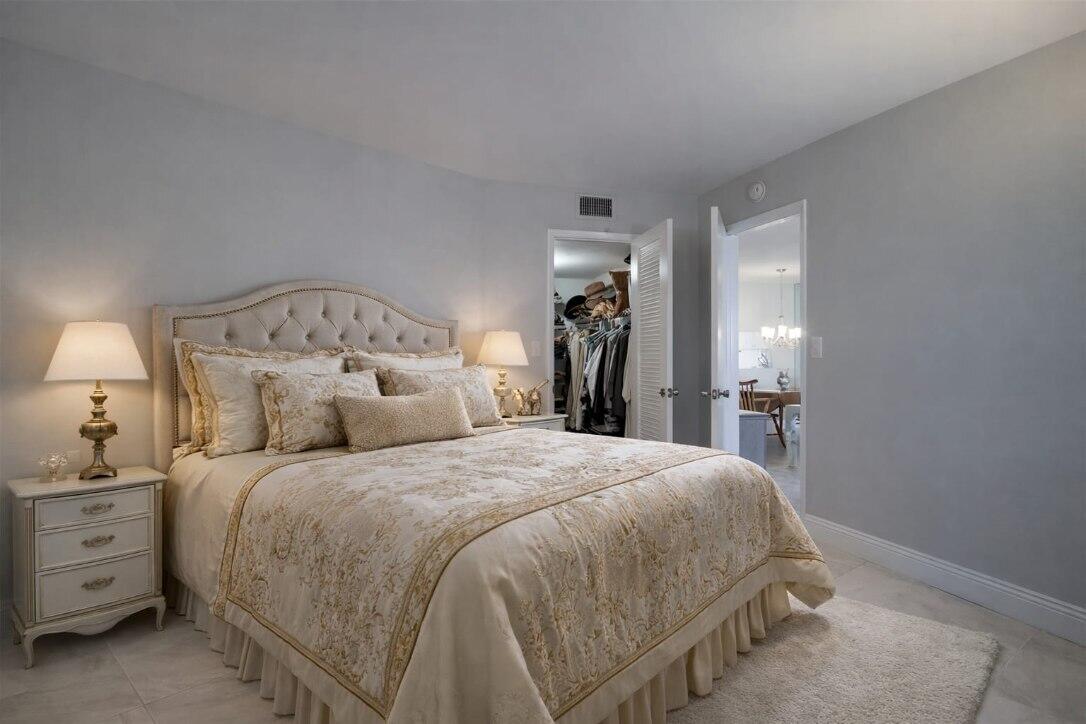 4500 North Federal Highway, Unit 121C Lighthouse Point, FL 33064 - Photo 8 of 14 a bedroom with a bed and a mirror