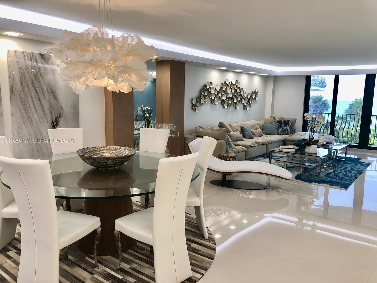 8877 Collins Avenue, Unit 308 Surfside, FL 33154 - Photo 11 of 22 a living room with furniture and a large window