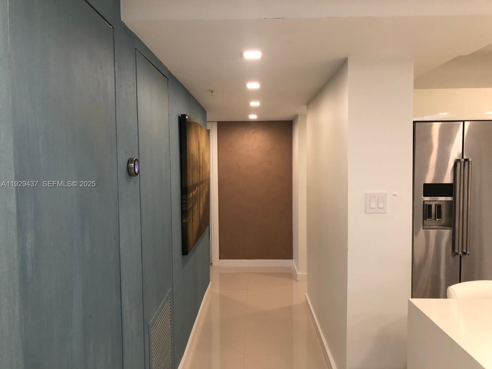 8877 Collins Avenue, Unit 308 Surfside, FL 33154 - Photo 18 of 22 a view of hallway with stainless steel appliances wooden floor and staircase