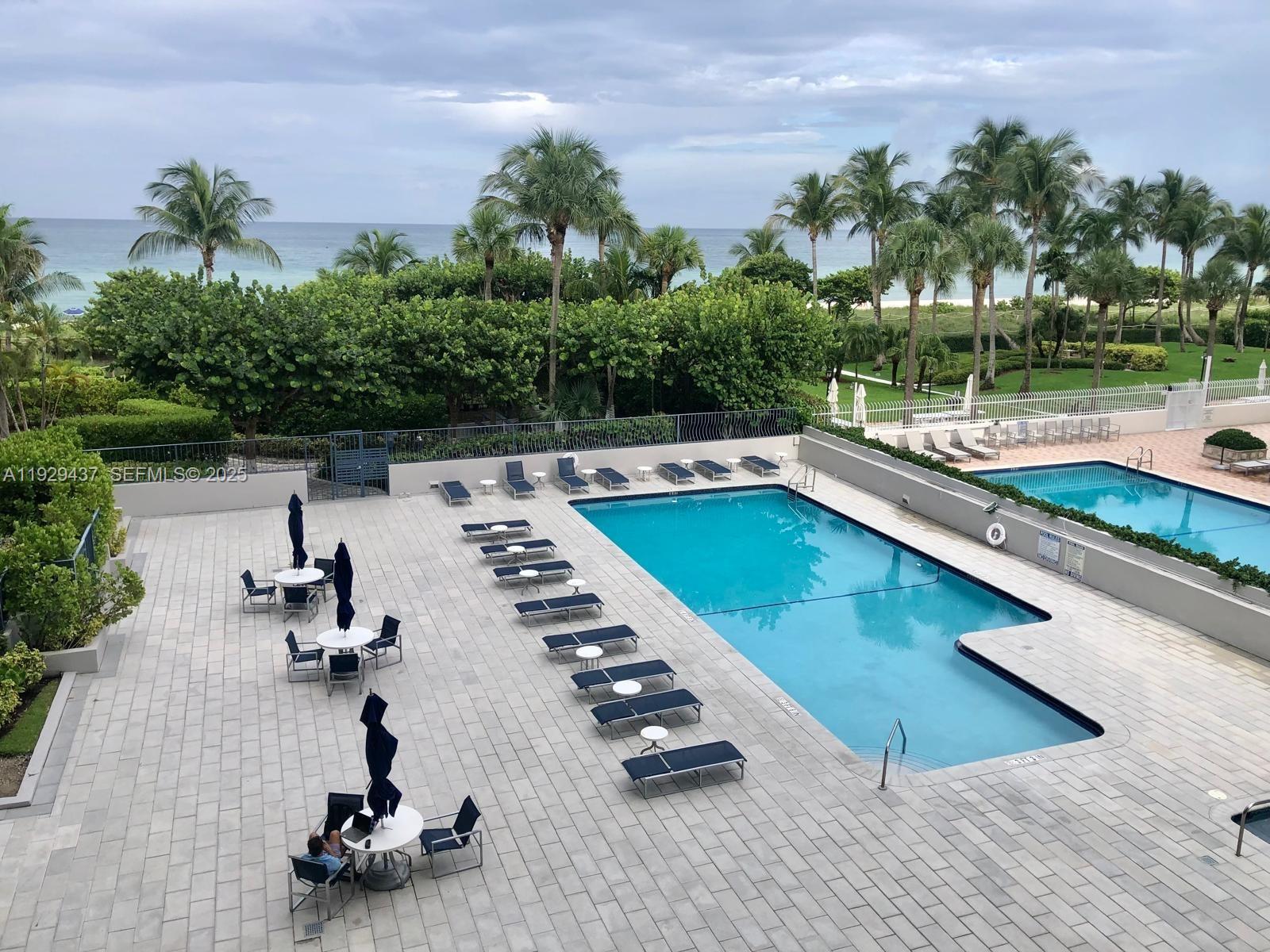 8877 Collins Avenue, Unit 308 Surfside, FL 33154 - Photo 2 of 22 a view of swimming pool with chairs