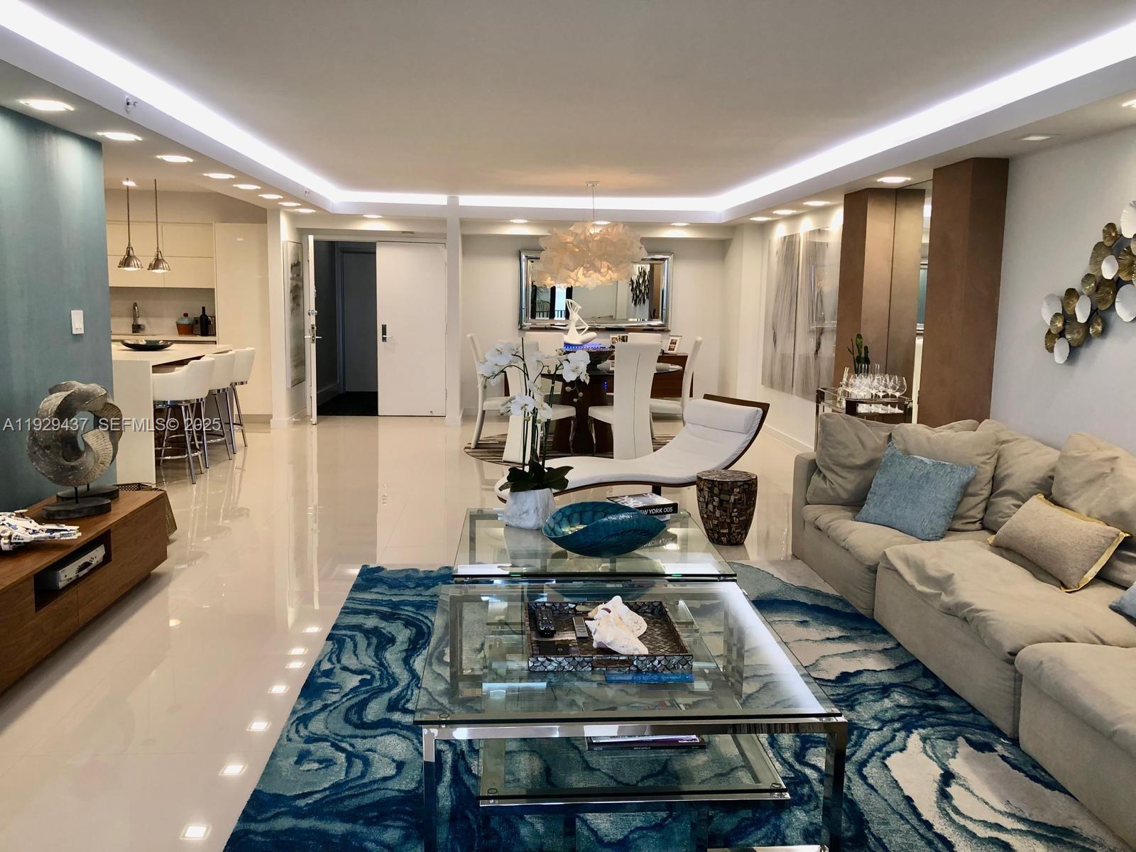 8877 Collins Avenue, Unit 308 Surfside, FL 33154 - Photo 21 of 22 a living room with furniture and a table