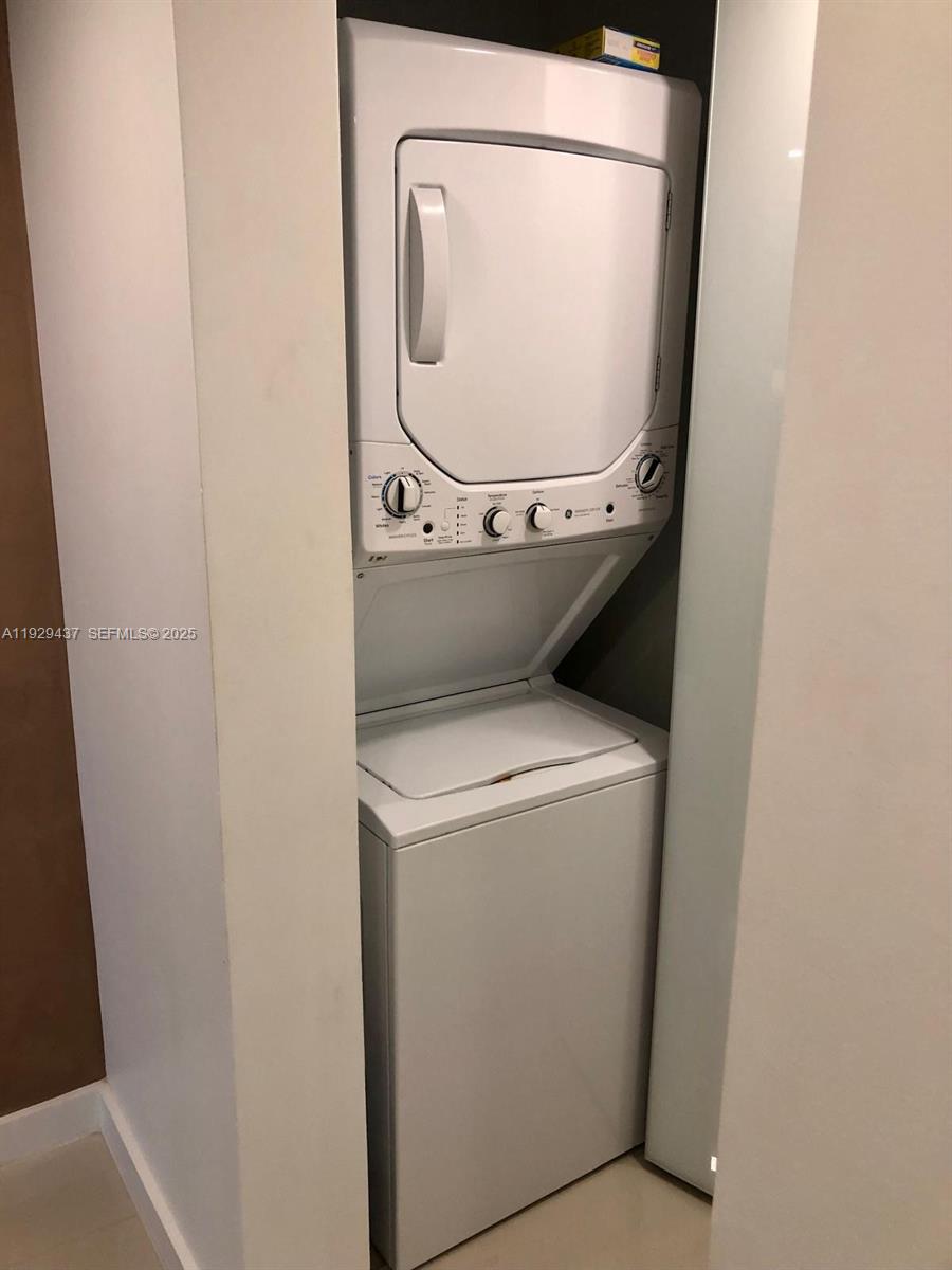 8877 Collins Avenue, Unit 308 Surfside, FL 33154 - Photo 8 of 22 a utility room with dryer and washer