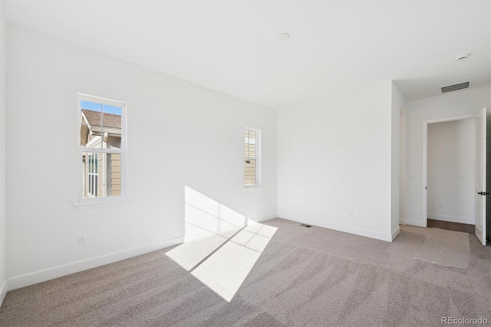 1242 Summit Rise Drive Erie, CO 80516 - Photo 16 of 25 an empty room with windows