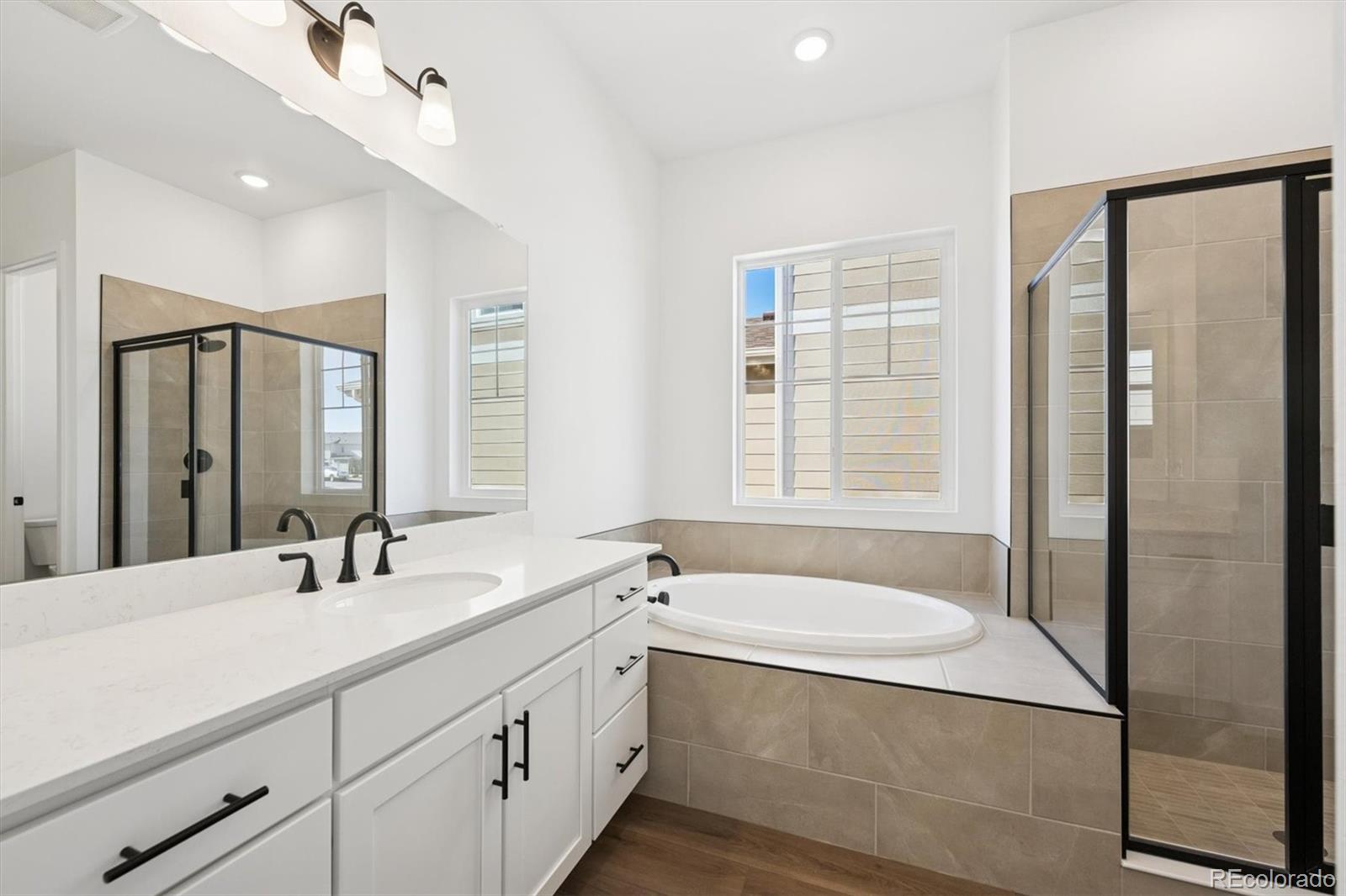 1242 Summit Rise Drive Erie, CO 80516 - Photo 17 of 25 a bathroom with double vanity and a bathtub
