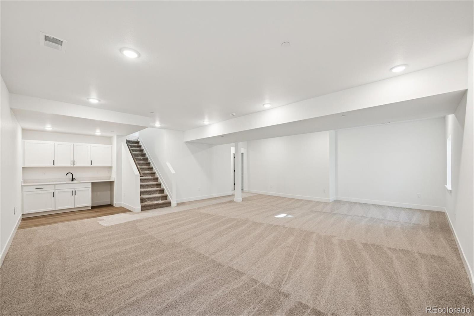 1242 Summit Rise Drive Erie, CO 80516 - Photo 20 of 25 a view of an empty room with a kitchen
