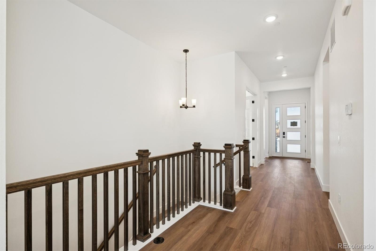 1242 Summit Rise Drive Erie, CO 80516 - Photo 2 of 25 a view of hallway with wooden floor