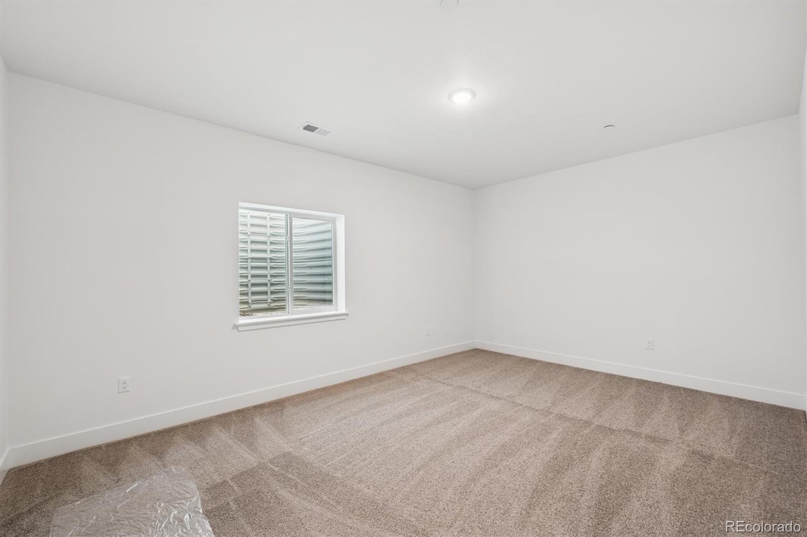 1242 Summit Rise Drive Erie, CO 80516 - Photo 21 of 25 an empty room with a window
