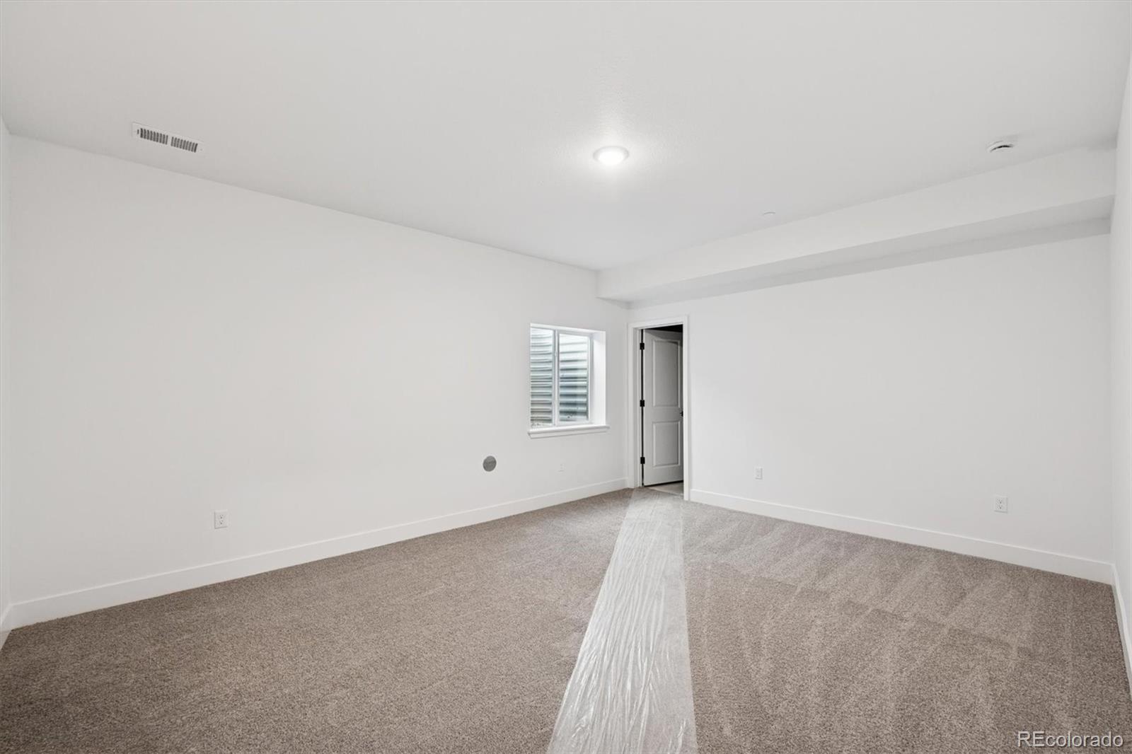 1242 Summit Rise Drive Erie, CO 80516 - Photo 23 of 25 a view of an empty room with a window