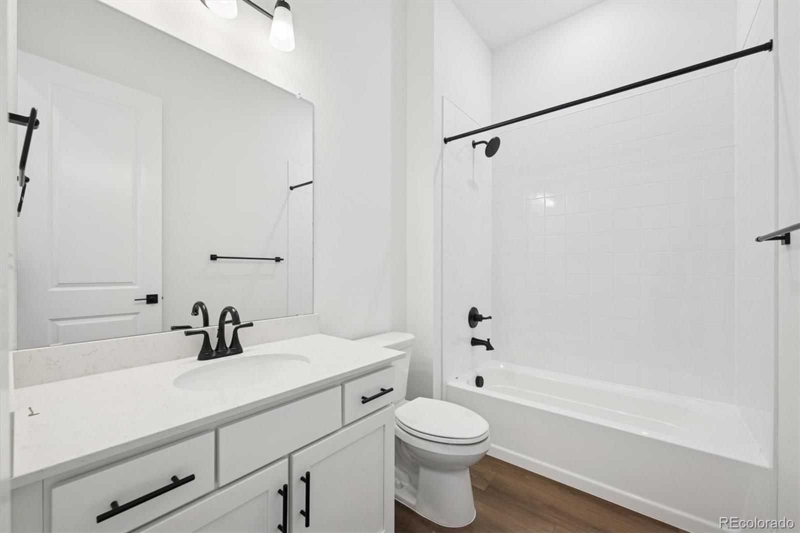 1242 Summit Rise Drive Erie, CO 80516 - Photo 4 of 25 a bathroom with a sink a toilet a mirror and shower