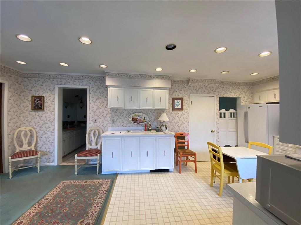 147 Warren Road Franklin, PA 16323 - Photo 17 of 40 a large kitchen with stainless steel appliances kitchen island granite countertop a large dining table and chairs