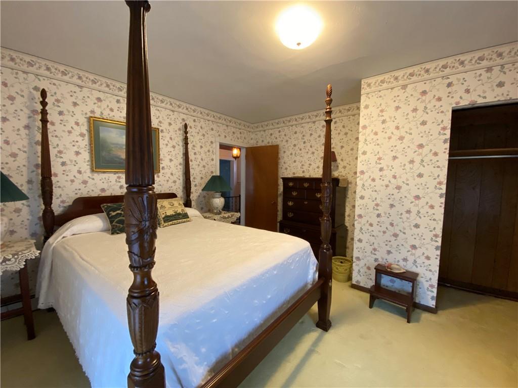 147 Warren Road Franklin, PA 16323 - Photo 30 of 40 a bedroom with a bed dresser and a flat tv screen
