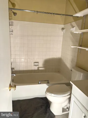 a bathroom with a toilet a sink and bathtub
