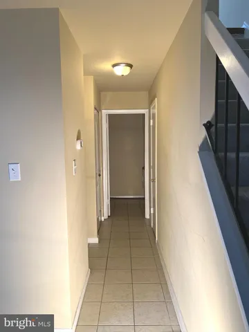 a view of a hallway with a dining table and chair
