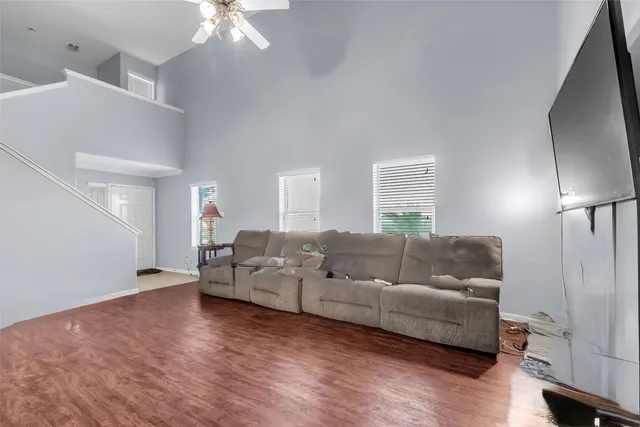 a living room with furniture and a chandelier