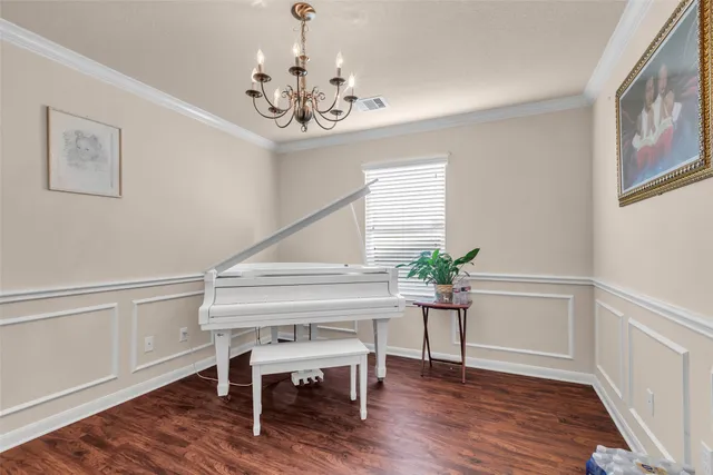 a view of a dining room with furniture wooden floor and chandelier