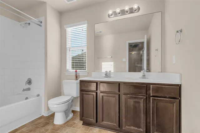 a bathroom with a sink a toilet and bathtub