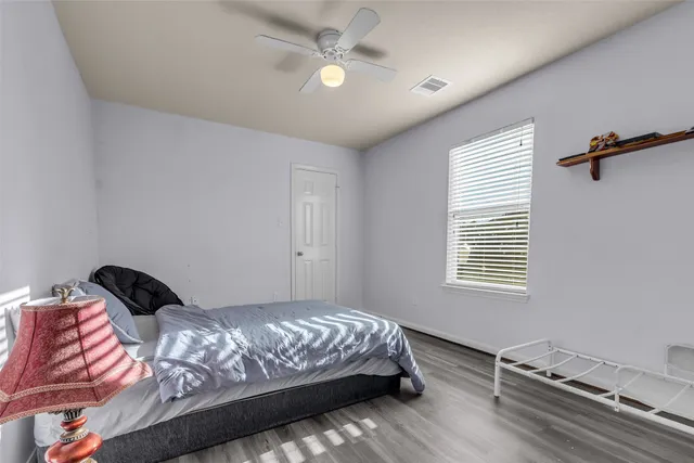 a bedroom with a bed and a window