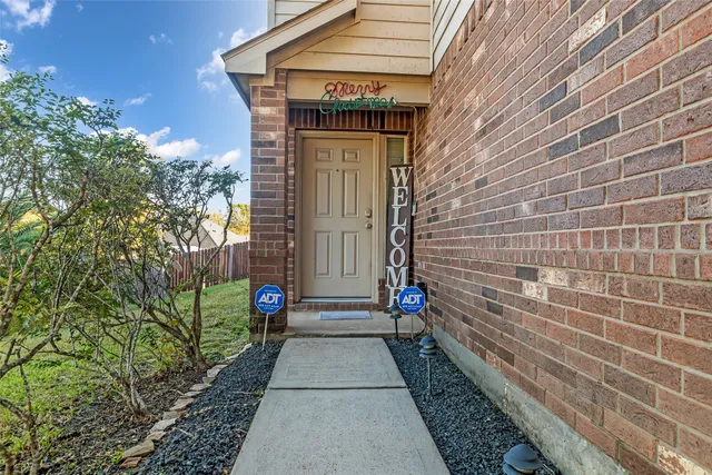 a pathway of a house with a yard